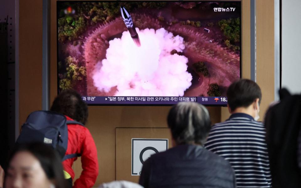 People watch a news report in Seoul after North Korea fires a space launch vehicle - Reuters