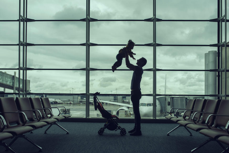Man lifting a baby at the airport