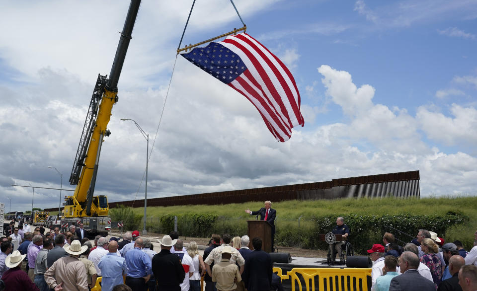 Former President Donald Trump, left, and Texas Gov. Greg Abbott, right, visit an unfinished section of border wall, in Pharr, Texas, Wednesday, June 30, 2021. (AP Photo/Eric Gay)