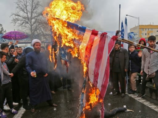 Iranians burn an American flag during commemorations of the 40th anniversary of the Islamic revolution in the capital Tehran on February 11, 2019