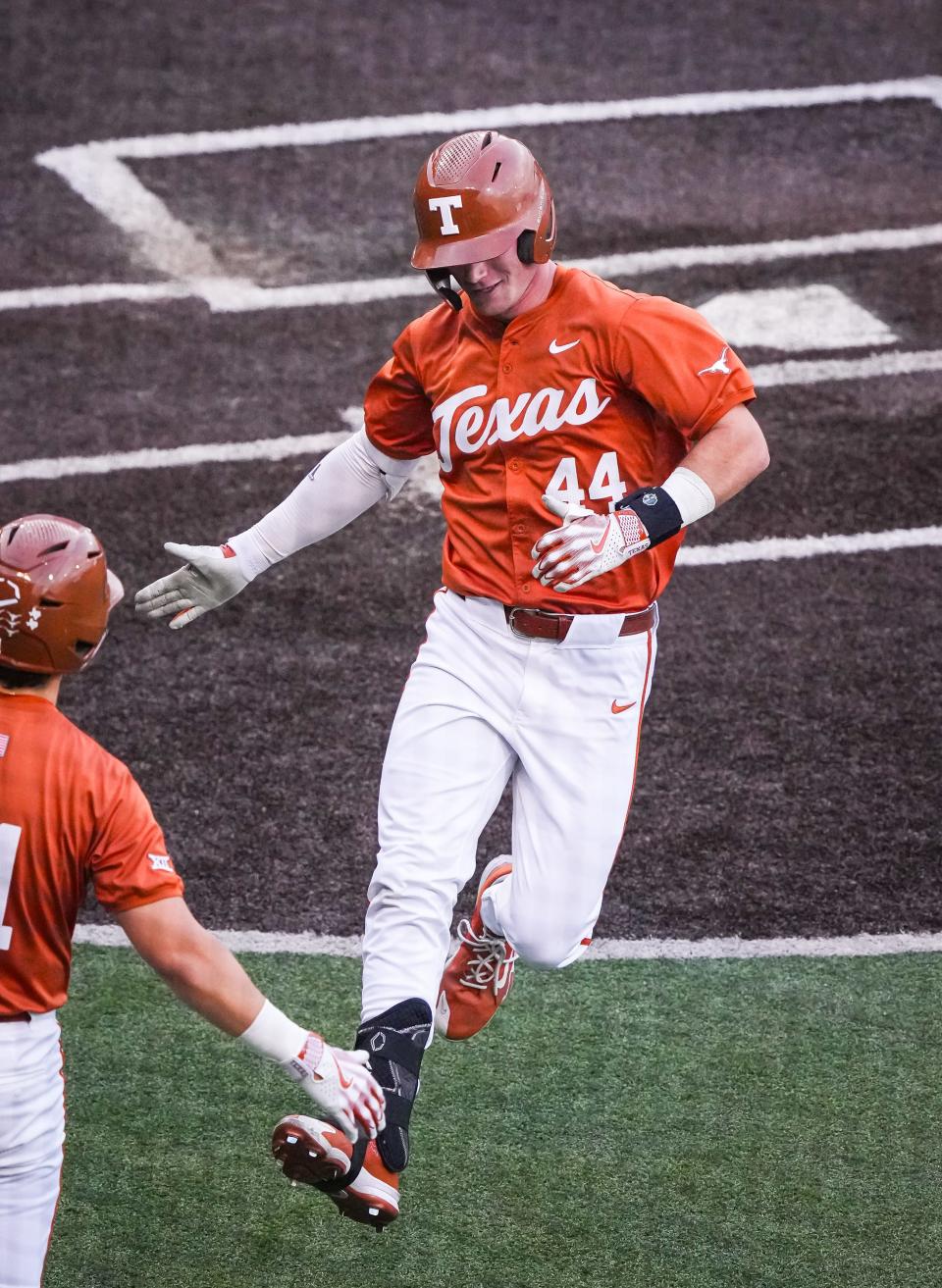 Texas' Max Belyeu celebrates with a teammate as he crosses home plate during an April 23 game against UT-Arlington. The Longhorns close out the regular season this weekend at home against Kansas.