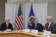 U.S. Vice President Mike Pence, who heads the government's coronavirus task force, listens during a meeting with 3M CEO, Mike Roman and Minnesota governor, Tim Walz, at the 3M company's headquarters in Maplewood