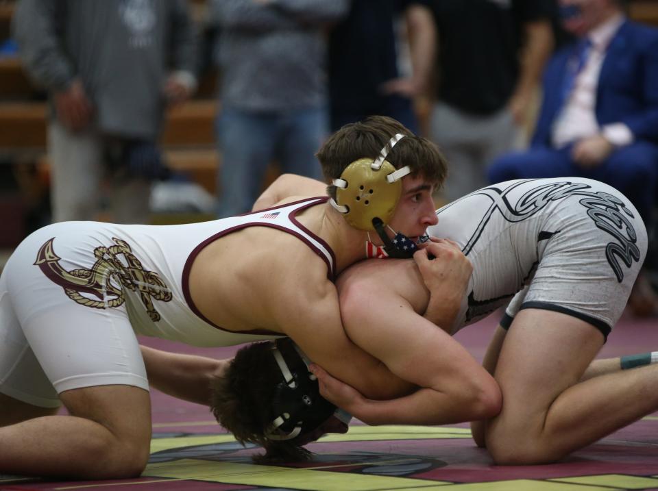 From left, Arlington's Tim Bova wrestles against Xavier's Colin Loria during the championship match for the 152lb weight class during the Mid Hudson Wrestling Tournament in Freedom Plains on December 28, 2021. Bova won by fall. 