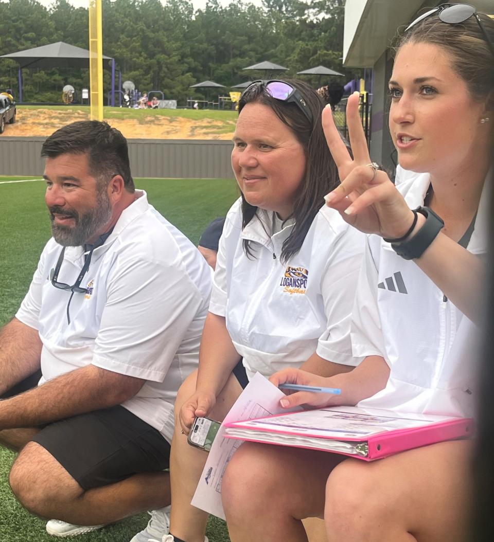 Logansport coaches Kyle Creech, Jen Wheless and Bailey Coburn watch their Lady Tigers win a playoff game.