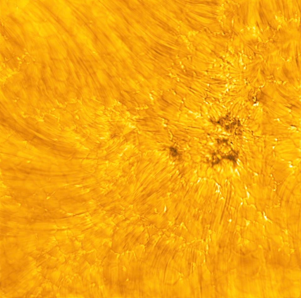 a turblent segment of the sun's surface where wind-like curving lines of the upper atmosphere sweep over plasma cells and dark pores below