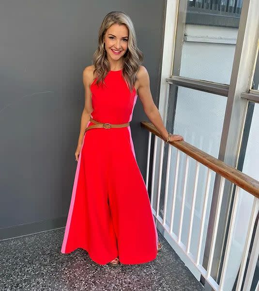 Helen Skelton posing in a bright red jumpsuit