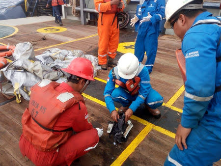 Workers of PT Pertamina examine recovered debris of what is believed to be from the crashed Lion Air flight JT610, onboard Prabu ship owned by PT Pertamina, off the shore of Karawang regency, West Java province, Indonesia, October 29, 2018. Antara Foto/PT Pertamina/Handout via REUTERS