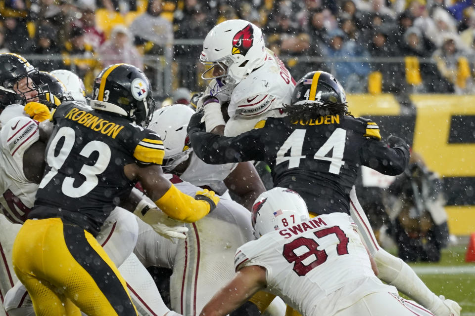 Arizona Cardinals running back James Conner, center, scores a touchdown as he beats Pittsburgh Steelers linebackers Markus Golden (44) and Mark Robinson (93) to the endzone during the second half of an NFL football game Sunday, Dec. 3, 2023, in Pittsburgh. (AP Photo/Gene J. Puskar)