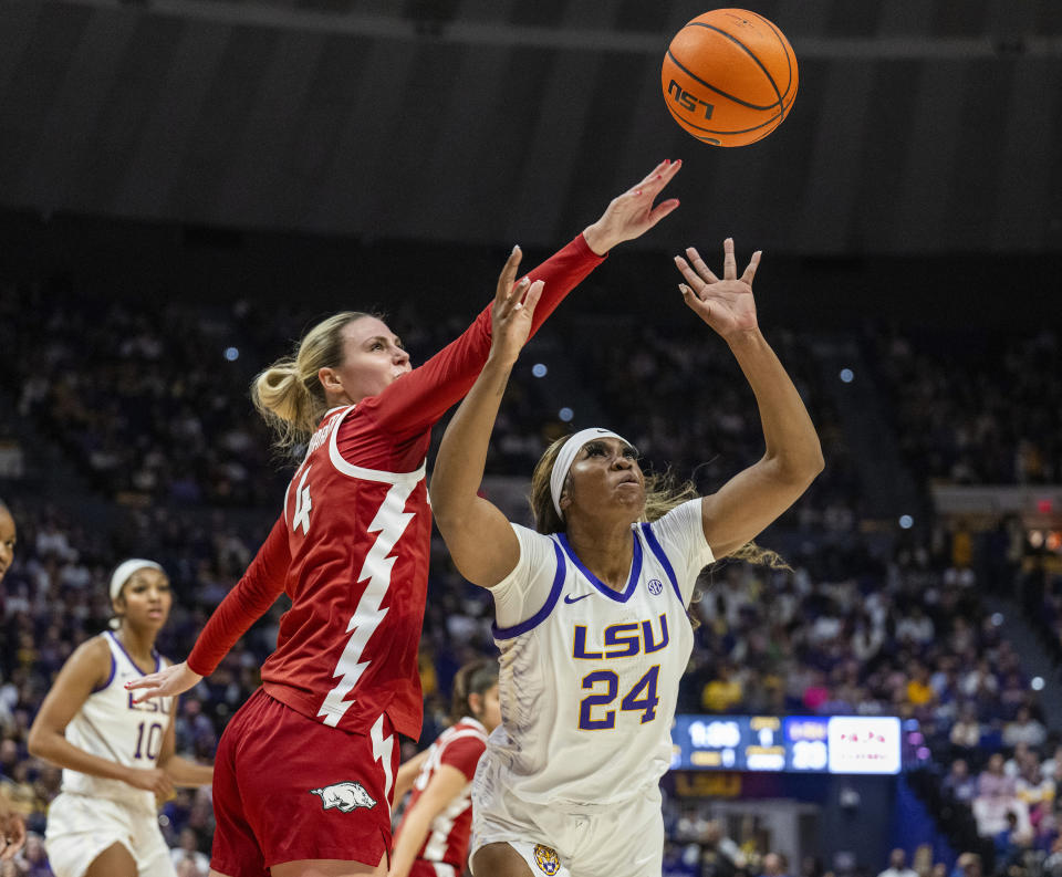 LSU guard Aneesah Morrow (24) has the ball knocked away by Arkansas guard Saylor Poffenbarger (4) in the second period of an NCAA college basketball game Sunday, Jan. 21, 2024, in Baton Rouge, La. (Michael Johnson/The Advocate via AP)