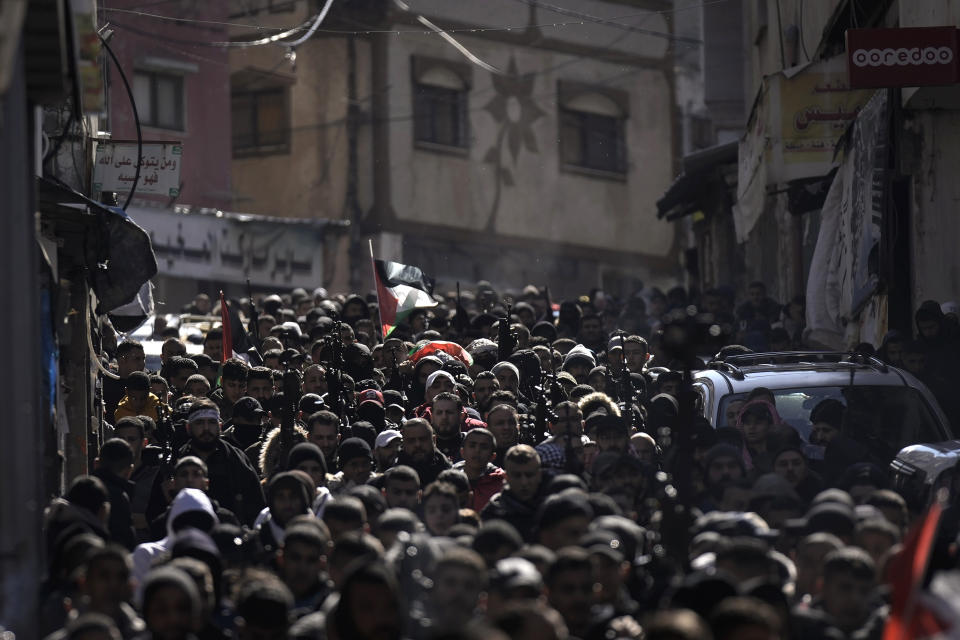 Palestinian mourners carry the body of Hamza al-Ashqar, 17, during his funeral in the Askar refugee camp near the West Bank city of Nablus, Tuesday, Feb. 7, 2023. The Palestinian Health Ministry says that Israeli troops killed the teenager, who died of a gunshot wound to the head during a raid. The Israeli military said its troops came under attack during a raid in Nablus, where soldiers fired at an armed Palestinian who shot at them. (AP Photo/Majdi Mohammed)