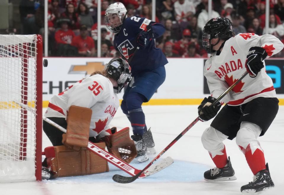 American forward Hilary Knight scores a goal against Canadian goaltender Ann-Renée Desbiens during the second period of the women's hockey world championship gold-medal game on Sunday at the CAA Centre in Brampton, Ont.