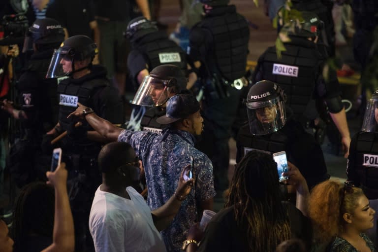 Protesters face riot police during a demonstration against police brutality in Charlotte, North Carolina, on September 21, 2016