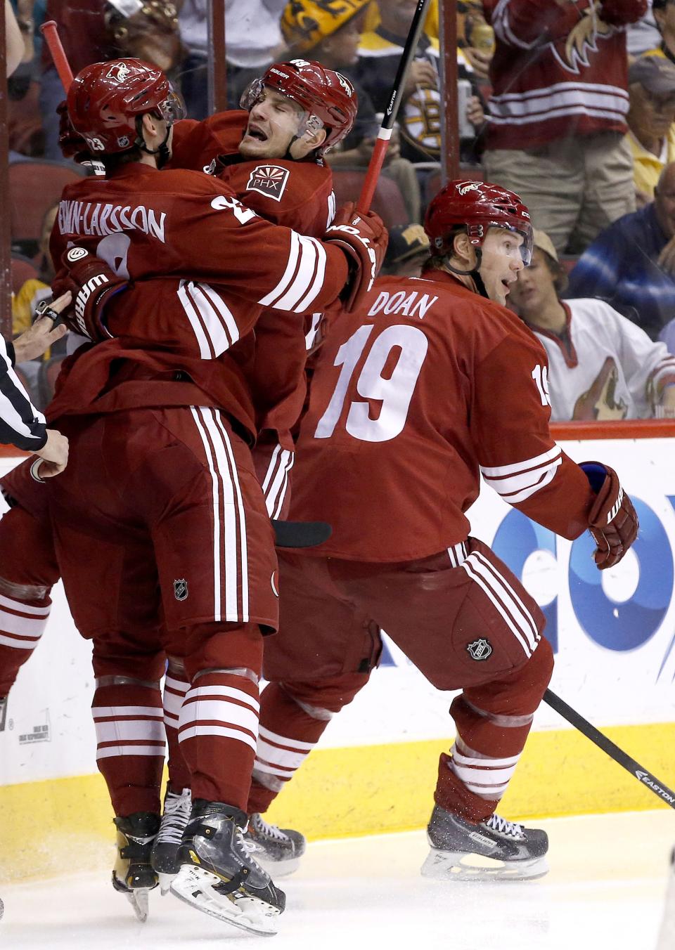 Phoenix Coyotes' Oliver Ekman-Larsson, left, of Sweden, celebrates his goal against the Boston Bruins with teammates Mikkel Boedker, of Denmark, and Shane Doan (19) during the second period of an NHL hockey game on Saturday, March 22, 2014, in Glendale, Ariz. (AP Photo/Ross D. Franklin)