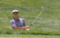 Rickie Fowler hits from the sand on the first hole during the third round of the Memorial golf tournament Saturday, June 1, 2019, in Dublin, Ohio. (AP Photo/Jay LaPrete)