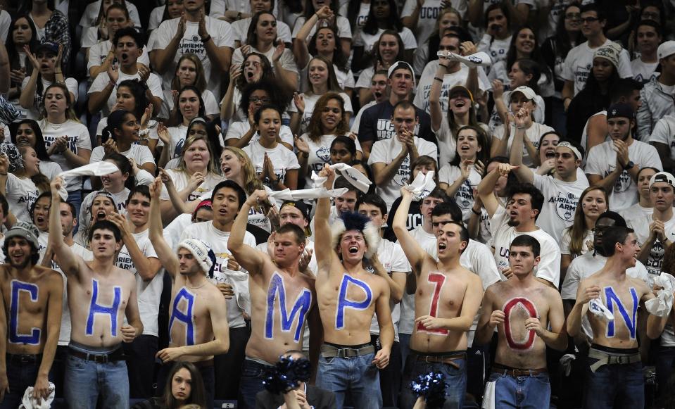 Fans in the Connecticut student section wave items during the second half of an NCAA college basketball game between UConn and Notre Dame, Saturday, Dec. 5, 2015, in Storrs, Conn. UConn won 91-81. (AP Photo/Jessica Hill)