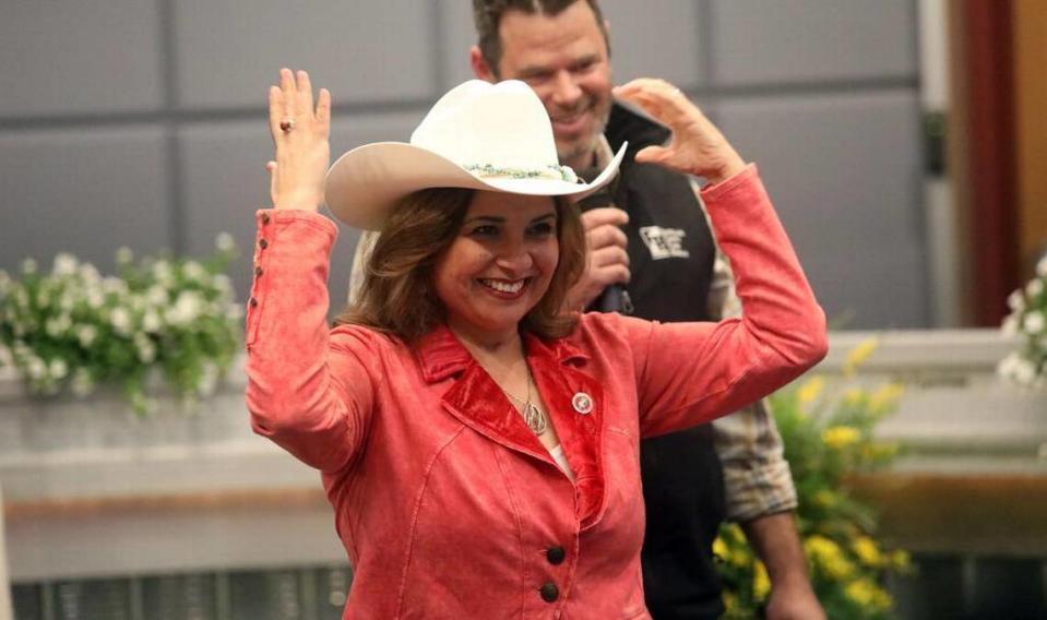 State Sen. Marie Alvarado-Gil shows off the hat she received from Stanislaus County Farm Bureau President Eric Heinrich during her community swearing-in ceremony at the Modesto Irrigation District board room on March 16, 2023. About 125 people showed up.