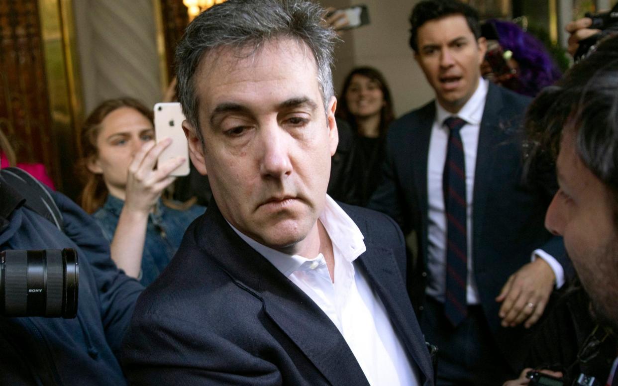 Michael Cohen, former attorney to President Donald Trump, leaves his apartment building before beginning his prison term in New York - Kevin Hagen/AP