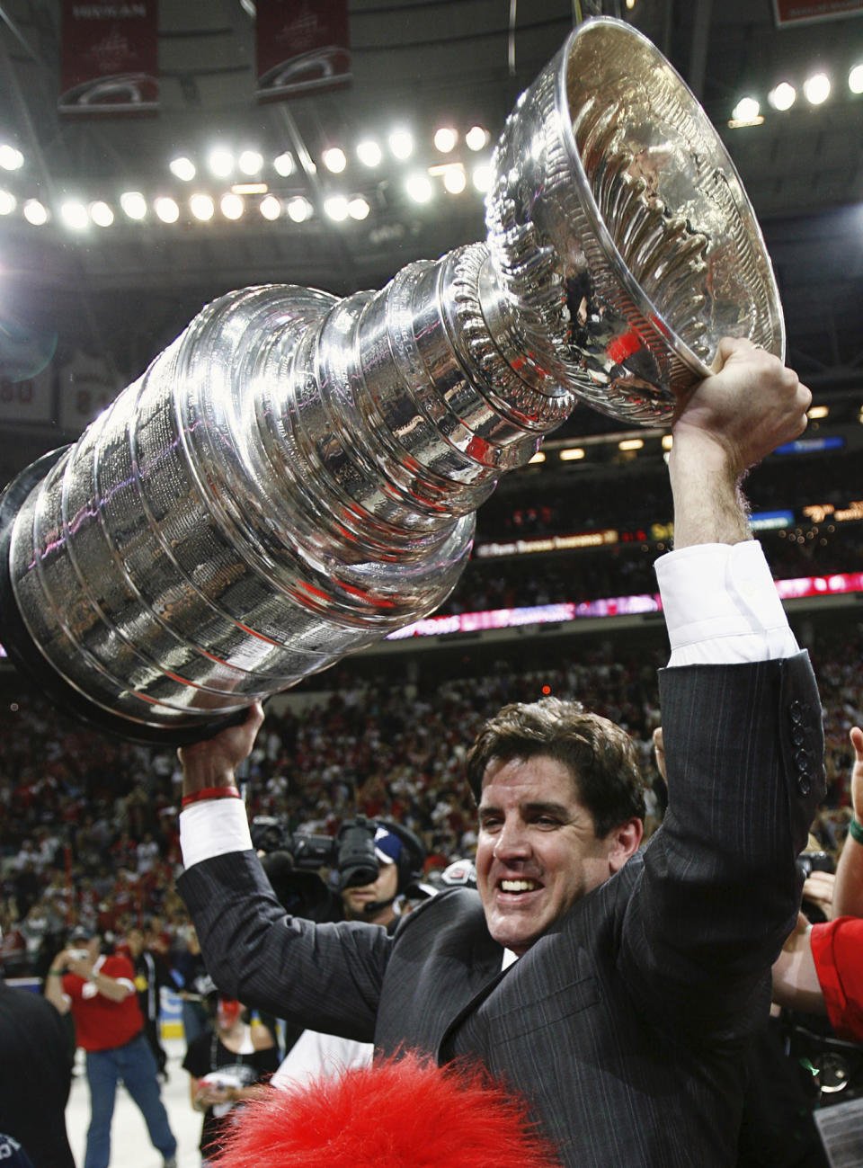 FILE - In this June 19, 2006, file photo, Carolina Hurricanes coach Peter Laviolette celebrates with the NHL hockey Stanley Cup after Game 7 of the finals against the Edmonton Oilers in Raleigh, N.C. The New York Rangers have hired Laviolette as their next coach, bringing in a seasoned veteran with Stanley Cup-winning experience to replace Gerard Gallant, the team announced Tuesday, June 13, 2023. (Paul Chiasson/The Canadian Press via AP, File)