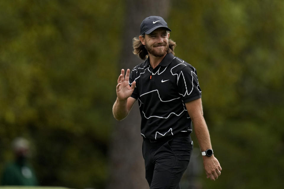 Tommy Fleetwood, of England, waves to the gallery as he walks up the first fairway during the first round of the Masters golf tournament on Thursday, April 8, 2021, in Augusta, Ga. (AP Photo/Matt Slocum)