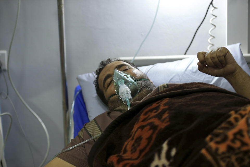 A man is treated for breathing difficulties after inhaling chlorine gas from Monday's toxic gas explosion in Jordan's Red Sea port of Aqaba, Tuesday, June 28, 2022. A crane loading chlorine tanks onto a ship on Monday dropped one of them, causing an explosion of toxic yellow smoke that killed over a dozen people and sickened some 250, authorities said. (AP Photo/Raad Adayleh)