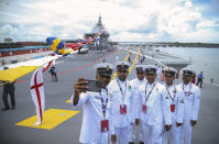 Navy sailors pose for a selfie on the deck of India's first home-built aircraft carrier INS Vikrant, after it was commissioned in Kochi, India, Friday, Sept. 2, 2022. India is preparing to relaunch INS Vikramaditya aircraft carrier after a major refit, a critical step toward fulfilling its plan to deploy two carrier battle groups as it seeks to strengthen its regional maritime power to counter China's increasing assertiveness. (AP Photo/Prakash Elamakkara)
