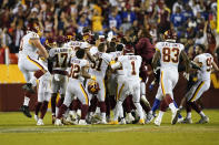 Members of the Washington Football Team celebrate kicker Dustin Hopkins' winning field goal against the New York Giants at the end of an NFL football game, Thursday, Sept. 16, 2021, in Landover, Md. Washington won 30 - 29. (AP Photo/Al Drago)