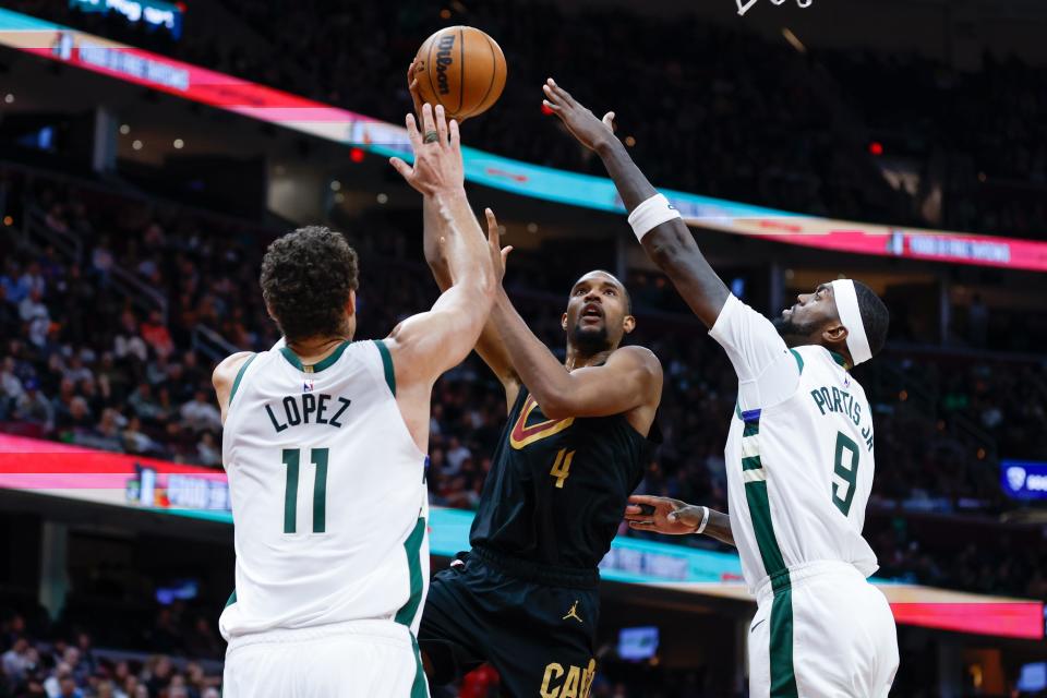 Cavaliers forward Evan Mobley shoots over Bucks center Brook Lopez (11) and forward Bobby Portis (9) during the second half, Saturday, Jan. 21, 2023, in Cleveland.