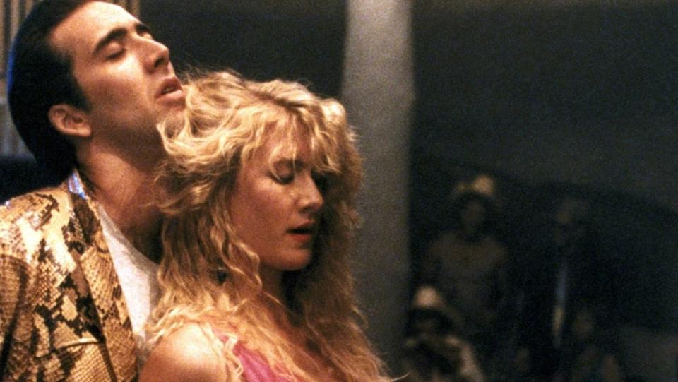 Nicolas Cage embraces Laura Dern from behind during a dance sequence from David Lynch's Wild at Heart.