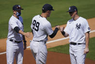 New York Yankees' Manager Aaron Boone, left, stands with Aaron Judge, center, and DJ LeMahieu as they are announced before a spring baseball game against the Toronto Blue Jays Sunday, Feb. 28, 2021, in Tampa, Fla. (AP Photo/Frank Franklin II)