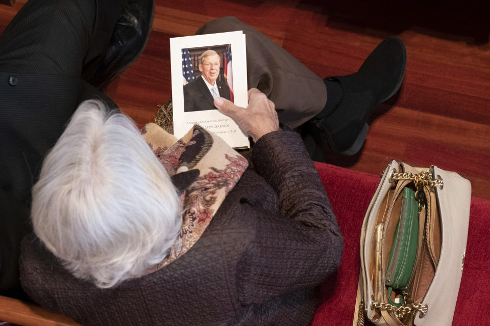 A woman holds a program before a funeral service for former Sen. Johnny Isakson at Peachtree Road United Methodist Church, Thursday afternoon, Jan. 6, 2022, in Atlanta. Isakson, 76, died Dec. 19, 2021, at his home in Atlanta. (Ben Gray/Atlanta Journal-Constitution via AP)