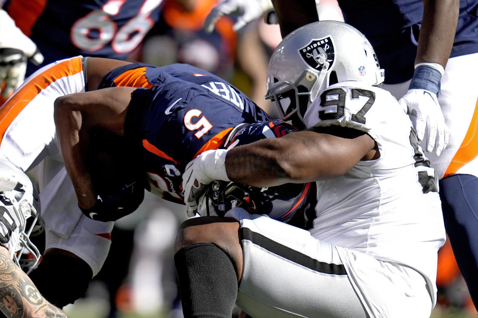 Denver Broncos quarterback Teddy Bridgewater (5) is sacked by Las Vegas Raiders defensive tackle Damion Square (97) during the first half of an NFL football game, Sunday, Oct. 17, 2021, in Denver. (AP Photo/Jack Dempsey)