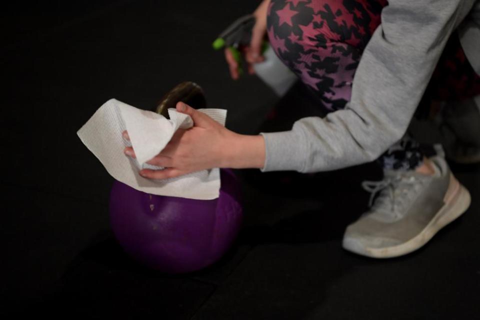 Gym goers wipe down equipment as they work out in Adelaide.