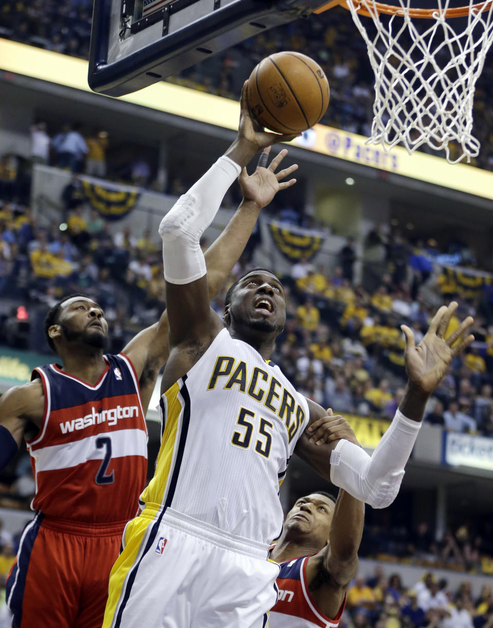 Indiana Pacers' Roy Hibbert (55) puts up a shot against Washington Wizards' John Wall (2) during the second half of game 2 of the Eastern Conference semifinal NBA basketball playoff series Wednesday, May 7, 2014, in Indianapolis. Indiana won 86-82. (AP Photo/Darron Cummings)