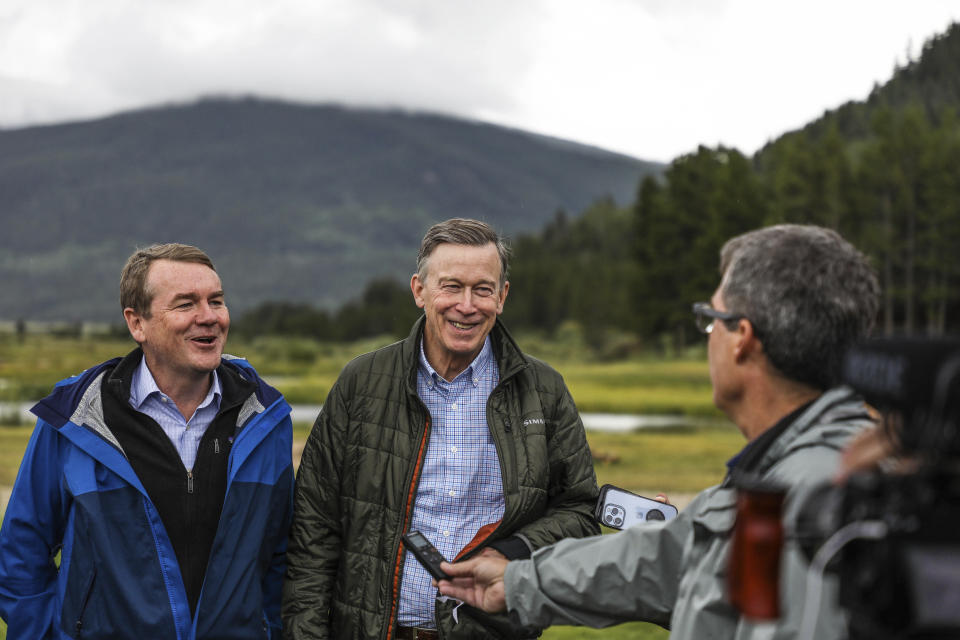 FILE - Sen. Michael Bennet D-Colo. left, and Sen. John Hickenlooper, D-Colo. talk to the media about the CORE Act Tuesday, Aug. 16, 2022 at Camp Hale, Colo. Top Colorado Democrats are asking President Joe Biden to declare a new national monument in the heart of the state's Rocky Mountains. The monument would be called Camp Hale - Continental Divide National Monument. (Chris Dillmann/Vail Daily via AP)