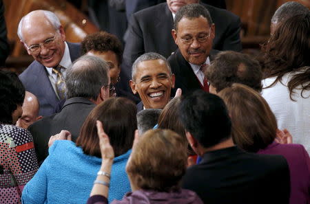 U.S. President Barack Obama is greeted by members of Congress as he arrives to deliver his State of the Union address to a joint session of Congress in Washington January 12, 2016. REUTERS/Kevin Lamarque