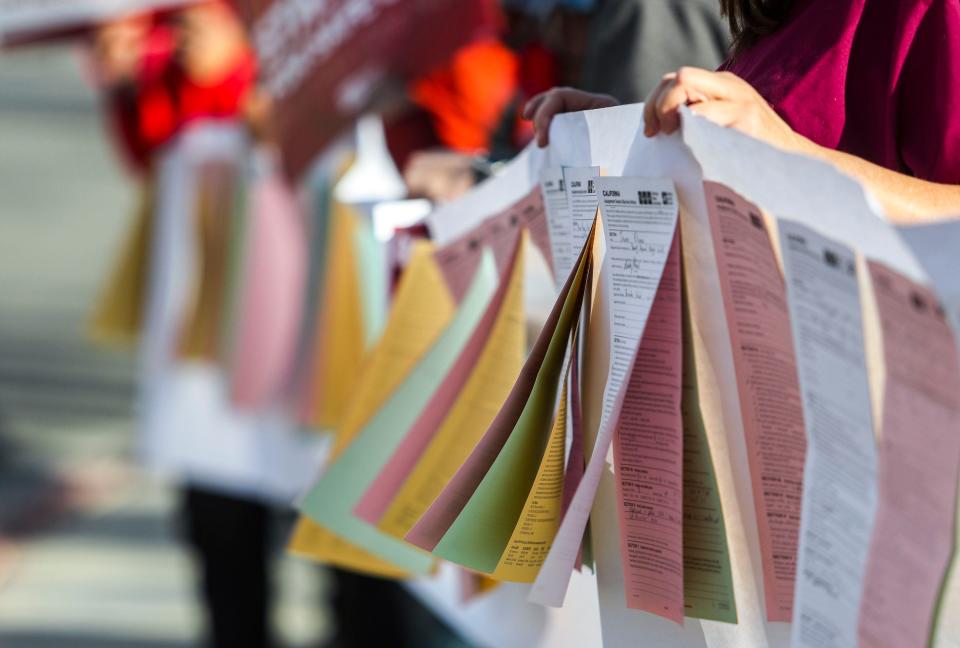 A banner of around 75 Assignment Despite Objection forms is seen made up of forms filled out by nurses in the last two months outside of Desert Regional Medical Center, Thursday, Jan. 13, 2022, in Palm Springs, Calif. The forms are used to detail and document assignments that are considered unsafe to patients or staff by the individual nurse or team of nurses.