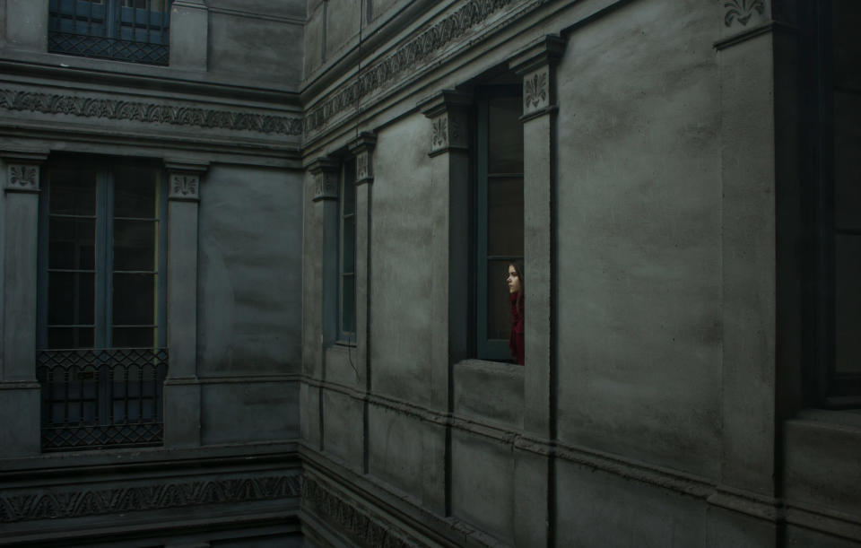 Youth 'Portraits' winner: Berta Vicente, Spain. A girl in red looks out of a dark building in 'Ariadna in Urquinaona' (Berta Vicente, Spain, Winner, Portraits, Youth Competition, 2013 Sony World Photography Awards)