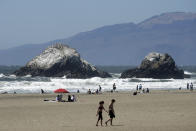 People visit Ocean Beach during the coronavirus outbreak in San Francisco, Sunday, July 5, 2020. Californians mostly heeded warnings to stay away from beaches and other public spaces during the long weekend as state officials urged social distancing amid a spike in coronavirus infections and hospitalizations. (AP Photo/Jeff Chiu)