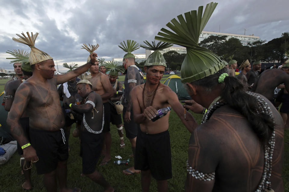 Xucuru indigenous people make apply paint during an annual three-day campout protest known as the Free Land Encampment, in Brasilia, Brazil, Wednesday, April 24, 2019. The event begins amid animosity between Brazil’s indigenous groups and the new government of far-right President Jair Bolsonaro. (AP Photo/Eraldo Peres)