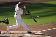 San Diego Padres' Austin Nola hits a sacrifice fly during the second inning of a National League wild-card series baseball game against the St. Louis Cardinals, Wednesday, Sept. 30, 2020, in San Diego. Jake Cronenworth scored on the play. (AP Photo/Gregory Bull)