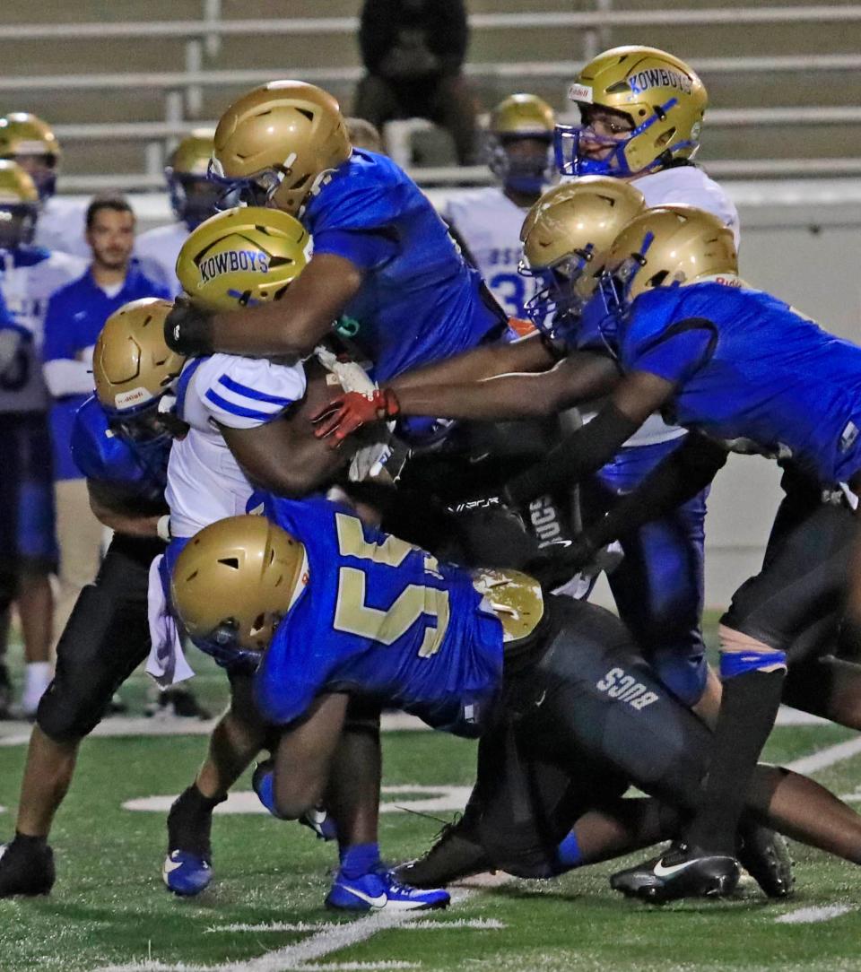 Mainland's defense swallows up an Osceola ball carrier during a 22-0 win on Thursday night.