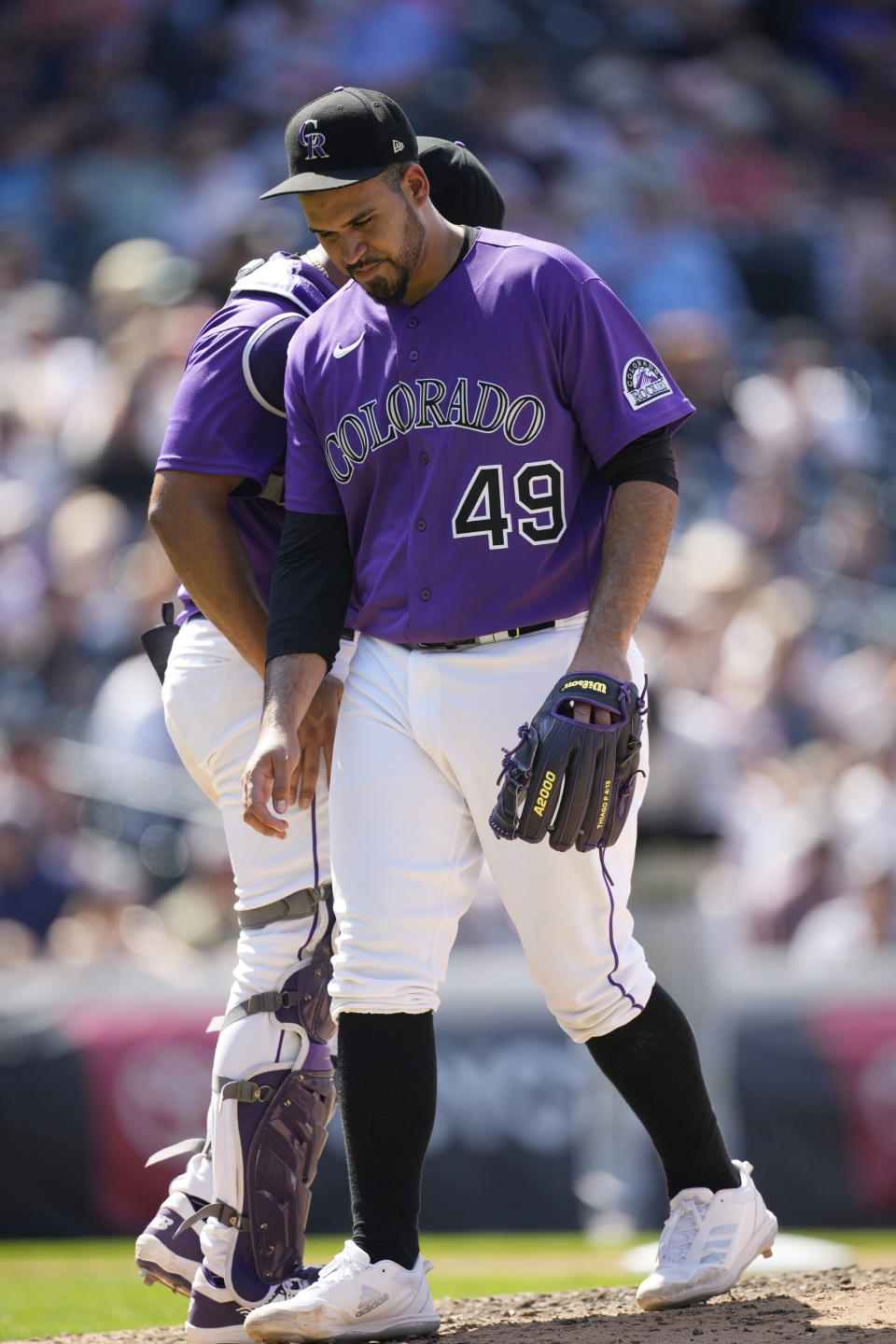 Colorado Rockies starting pitcher Antonio Senzatela heads to the dugout after taking a single off the right leg off the bat of Chicago White Sox's Leury Garcia in the seventh inning of a baseball game Wednesday, July 27, 2022, in Denver. (AP Photo/David Zalubowski)