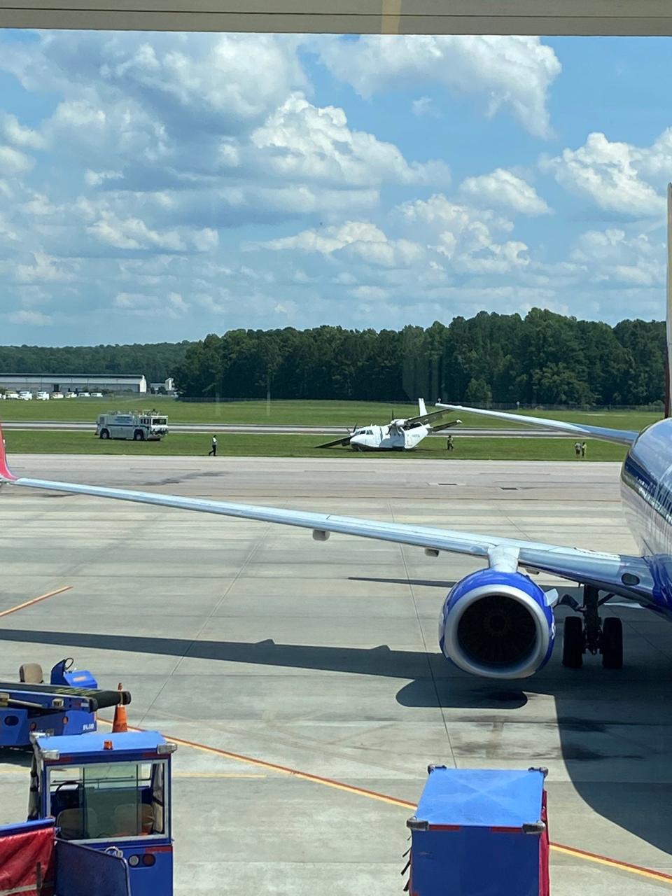 The twin-engine CASA CN-212 Aviocar after it landed on a grass area  at Raleigh-Durham International Airport.