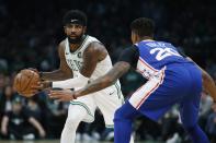 Boston Celtics' Kyrie Irving looks to pass against Philadelphia 76ers' Markelle Fultz (20) during the first half of an NBA basketball game in Boston, Tuesday, Oct 16, 2018. (AP Photo/Michael Dwyer)