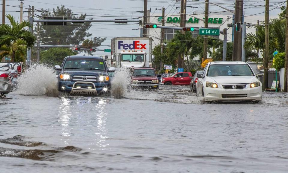 Cars drive through the flood at West 29th Street and 14th Avenue in Hialeah as torrential downpours inundate South Florida due to a disturbance off Florida’s coast on Thursday, November 16, 2023. Pedro Portal/pportal@miamiherald.com