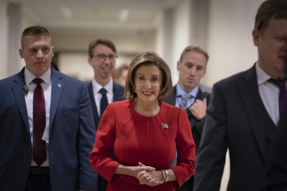 Speaker of the House Nancy Pelosi, D-Calif., arrives to talk to reporters on the morning after the first public hearing in the impeachment probe of President Donald Trump on his effort to tie U.S. aid for Ukraine to investigations of his political opponents, on Capitol Hill in Washington, Thursday, Nov. 14, 2019. Pelosi says the president's actions in the impeachment inquiry amount to "bribery." (AP Photo/J. Scott Applewhite)