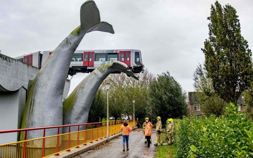 A Dutch metro train was saved from disaster on November 2, 2020, when it smashed through a safety barrier but was prevented from plummeting into water by a sculpture of a whale tail. - AFP