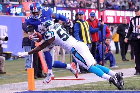 Dec 20, 2015; East Rutherford, NJ, USA; New York Giants tight end Will Tye (45) scores a touchdown against Carolina Panthers linebacker Thomas Davis (58) during the third quarter at MetLife Stadium. Mandatory Credit: Brad Penner-USA TODAY Sports