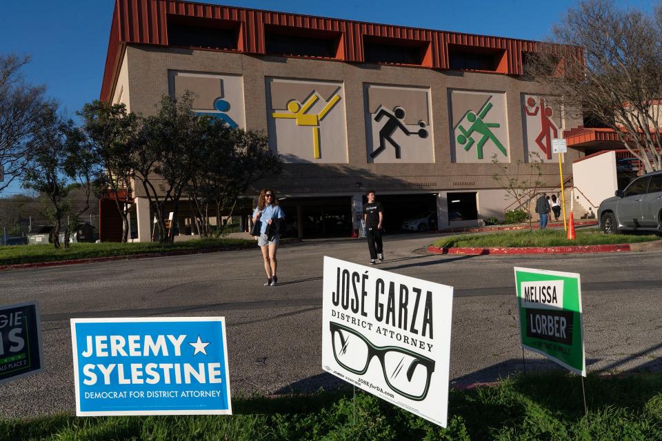 Super Tuesday voters exit the Austin Recreation Center after casting their ballots there.