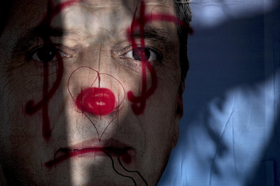 A defaced poster of Economy Minster Sergio Massa, a presidential hopeful, stands the day after primary elections in Buenos Aires, Argentina, Monday, Aug. 14, 2023. Massa finished third in total primary votes. (AP Photo/Natacha Pisarenko)